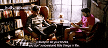 two men sit at a table reading books and playing chess with a quote from kulfyapp.com