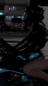 a woman wearing a helmet is riding a motorcycle
