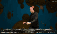 a dj playing music with smiley faces in the background and the words bynonofficial written on the bottom
