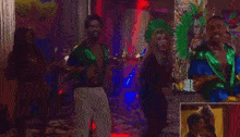 a group of people are dancing in a room with masks in the background