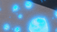 a bunch of blue bubbles are floating on the ground