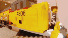 a yellow lego train with the number 4308 on it