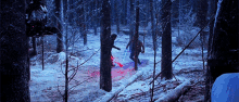a man is holding a red lightsaber in a snowy forest