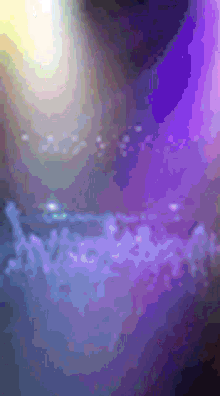 a blurry picture of a purple and blue background with a few bubbles in it .