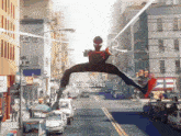 a man in a spiderman suit is jumping over a city street with blitzhelizard written on the bottom right