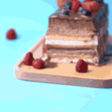 a cake with strawberries and blueberries on top of it