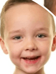 a close up of a child 's face with a smile on his face
