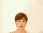 a close up of a woman 's face with short hair and red lips