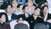a group of people are sitting in a theatre watching a movie