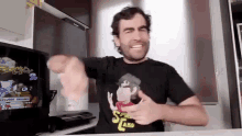 a man wearing a black shirt with a cartoon character on it .