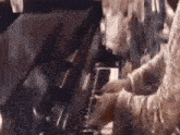 a close up of a person playing a piano in a room .