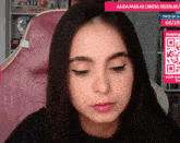a woman sitting in front of a screen that says ajuda para as contas ( r $ 100.00 / )