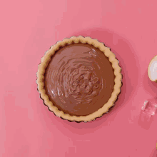a pie with chocolate and a pear on top