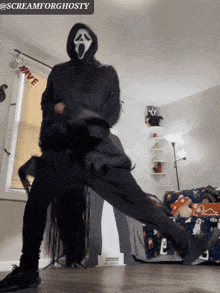 a man in a scream mask is holding another man in a living room
