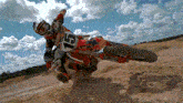 a person on a dirt bike with the number 5 on the front