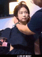 a woman in a black dress is being held by a man