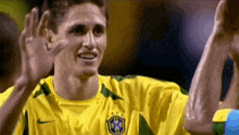 a man in a yellow shirt with the letters cbf on the front