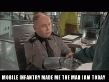 a man shaking hands with another man with the words mobile infantry made me the man i am today below him
