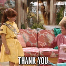 a girl in a yellow dress says " thank you "
