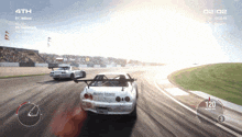 a video game screen shows two cars racing on a track and the number 4th is on the screen