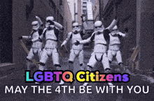 a group of stormtroopers are dancing in an alleyway with the words " lgbtq citizens may the 4th be with you "