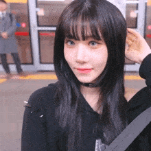 a girl with a choker around her neck is smiling