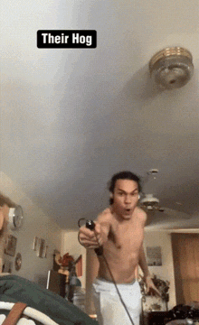 a shirtless man is playing a video game with a caption that says their hog