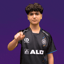 a young man wearing a black shirt that says aldi on it