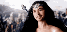a man with long hair and a beard is dressed as wonder woman holding a sword .