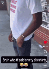 a man wearing a cheesy bread shirt is standing in front of a brick building