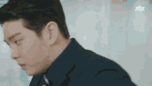 a close up of a man in a suit and tie .