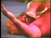 a blurry picture of a man laying on the ground with his mouth open