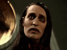 a close up of a person 's face with a strange expression