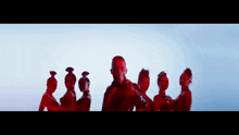 a group of women are standing in a line with a man standing in the middle