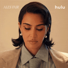 a woman wearing a suit and tie with the words all 's fair on the bottom