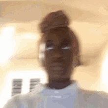 a blurry picture of a person 's face with a bun on their head