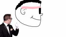 a man in a tuxedo is standing next to a drawing of a man with glasses