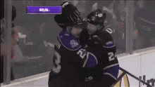 two hockey players wearing kings jerseys are standing next to each other on the ice