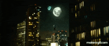 a city skyline at night with a full moon in the sky
