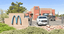 cars are parked in front of a mcdonald 's restaurant