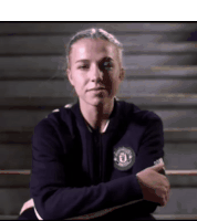 a woman wearing a black jacket with the word manchester on it