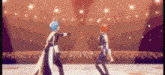two anime characters are dancing on a stage .