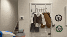 a child 's clothes are hanging on a clothes rack
