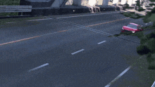 a red sports car is driving on a road