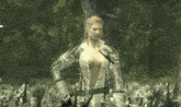 a woman in a video game is standing in a forest with a sword