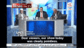 three men are sitting at a table in front of a screen that says memri tv