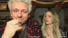 a man and a woman are sitting next to each other and the man is asking the woman if she is coincidence