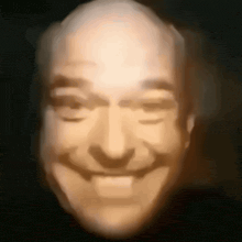 a close up of a bald man 's face with his eyes closed