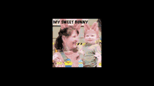 a woman is holding a baby wearing bunny ears and a sign that says my sweet bunny