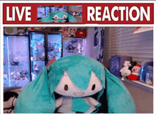 a stuffed animal is sitting in front of a sign that reads live reaction